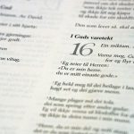 Close-up of open book with text pages.
